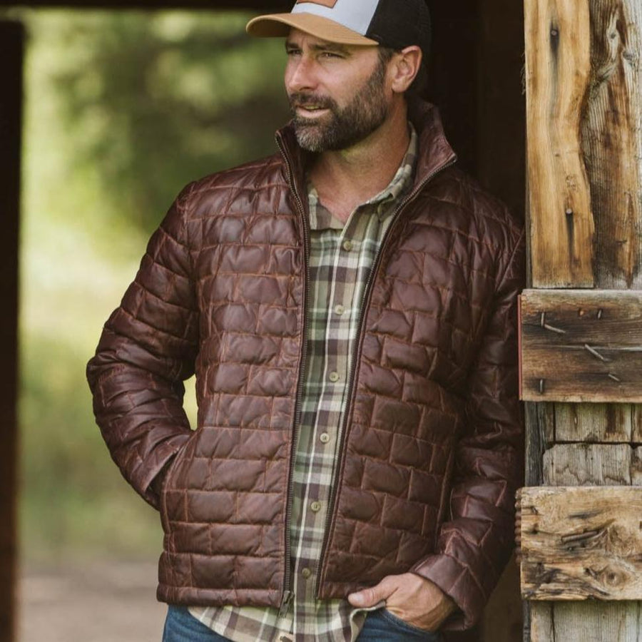 A mahogany brown leather light down jacket with a quilted pattern and a standing collar, zipper front, and side zip pockets.